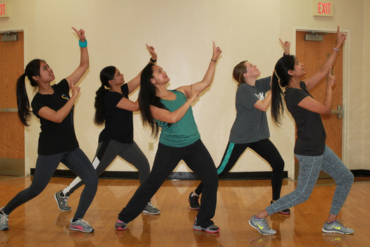 Happy women burning calories during Zumba at Freak Fit
